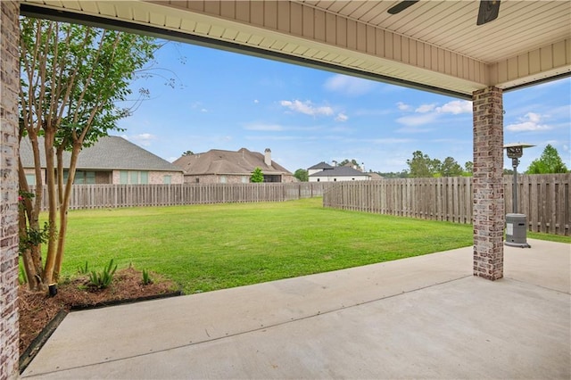 view of yard featuring a ceiling fan, a patio area, and a fenced backyard