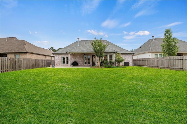 back of property featuring a patio, a yard, a fenced backyard, cooling unit, and brick siding
