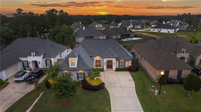 aerial view at dusk featuring a residential view