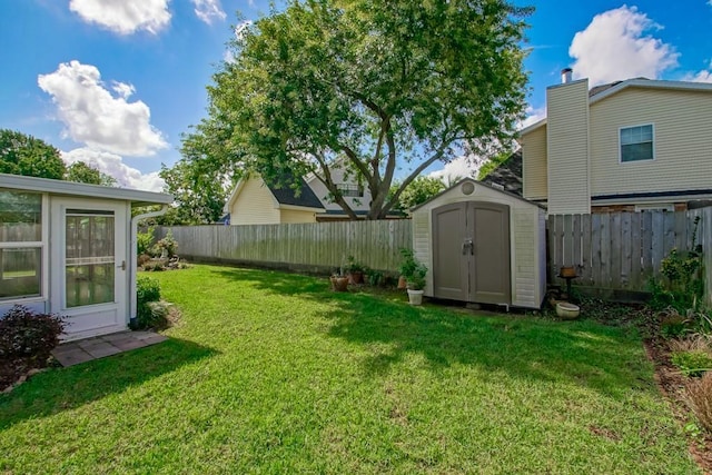 5 N Lafourche Ct, Kenner, LA 70065 - view of yard featuring an outdoor structure, a fenced backyard, and a storage shed