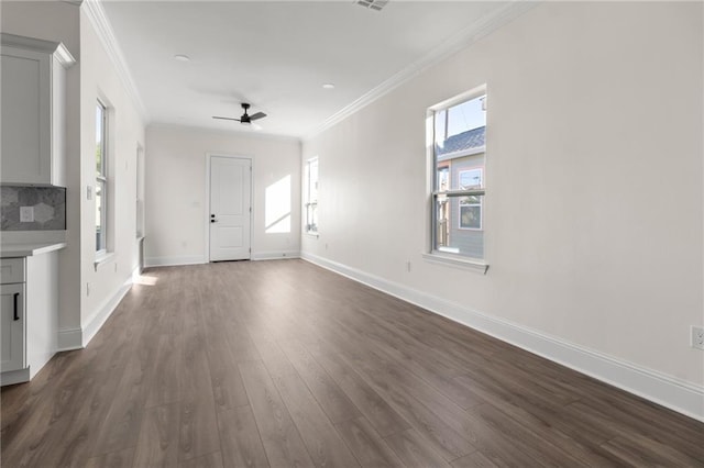 1704 Desire St, New Orleans, LA 70117 - unfurnished living room with crown molding, dark wood finished floors, ceiling fan, and baseboards