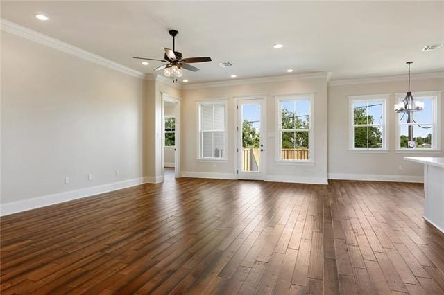 unfurnished living room featuring dark wood-style floors, crown molding, visible vents, baseboards, and ceiling fan with notable chandelier