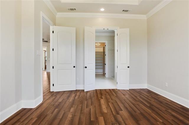 unfurnished bedroom featuring visible vents, ornamental molding, and baseboards