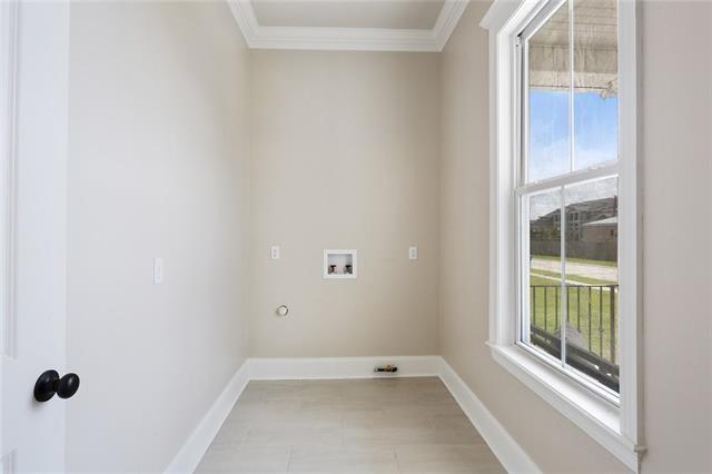 laundry area featuring ornamental molding, hookup for a washing machine, laundry area, and baseboards