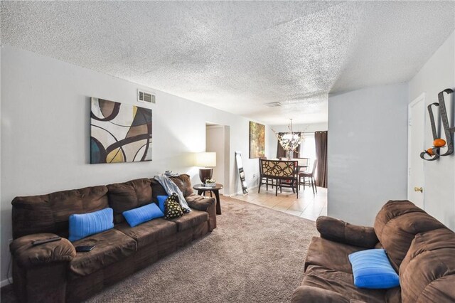 2805 Kingman St, Metairie, LA 70006 - living room featuring a chandelier, a textured ceiling, light carpet, and light tile patterned floors