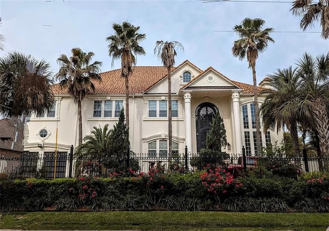 view of front of home with fence and stucco siding