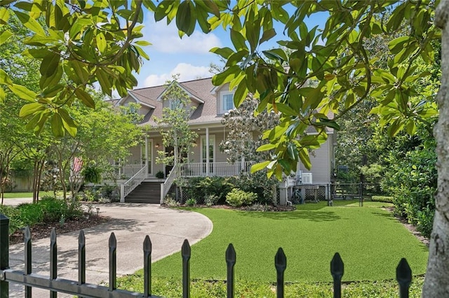 cape cod-style house featuring covered porch, fence, stairs, and a front lawn