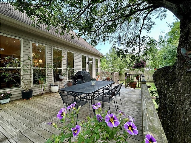 wooden deck with fence, outdoor dining space, and area for grilling