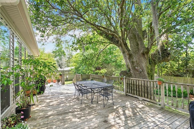 deck featuring a fenced backyard and outdoor dining area