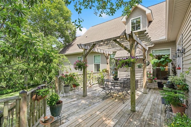 deck featuring outdoor dining area and a pergola