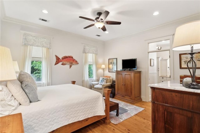 bedroom with multiple windows, light wood finished floors, and visible vents
