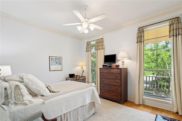 bedroom featuring baseboards, ornamental molding, light wood-style flooring, and ceiling fan