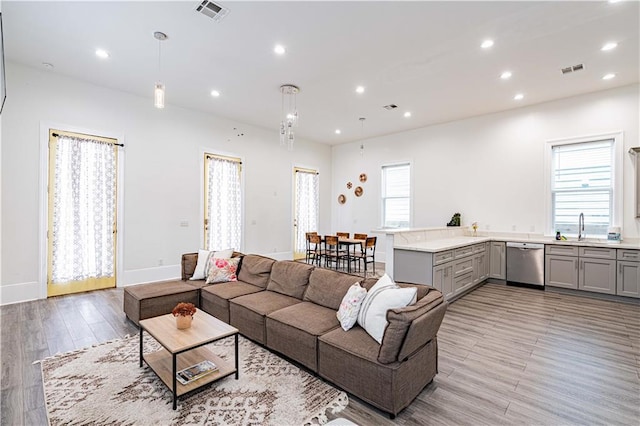1379 Saint Anthony St, New Orleans, LA 70116 - living room with visible vents, recessed lighting, and light wood-type flooring