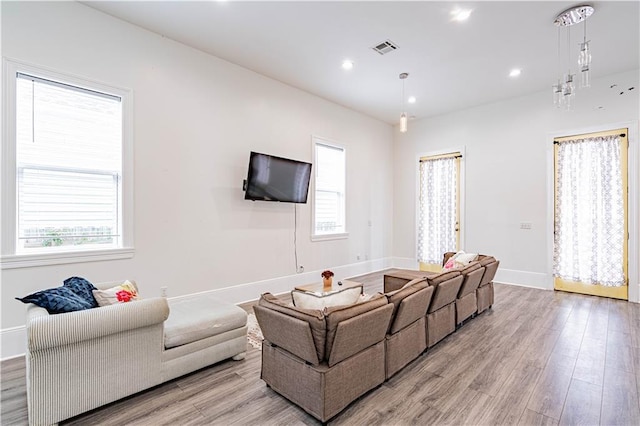 1379 Saint Anthony St, New Orleans, LA 70116 - living area with light wood-style floors, baseboards, plenty of natural light, and visible vents