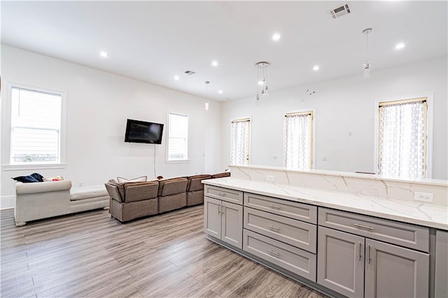1379 Saint Anthony St, New Orleans, LA 70116 - kitchen featuring gray cabinets, light wood-style flooring, recessed lighting, open floor plan, and visible vents