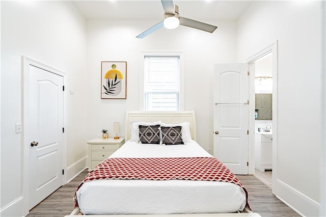 1379 Saint Anthony St, New Orleans, LA 70116 - bedroom with baseboards, ceiling fan, light wood-type flooring, and connected bathroom
