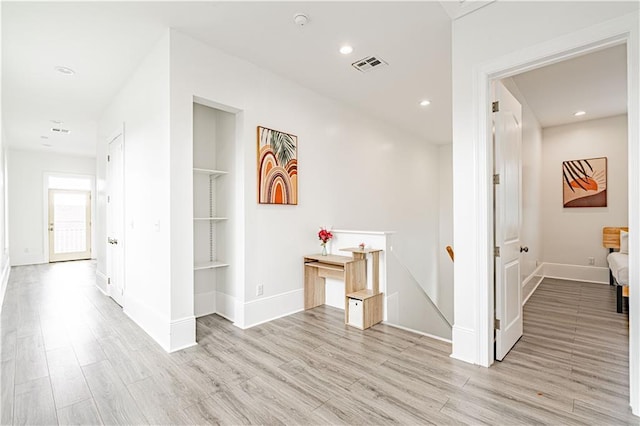 1379 Saint Anthony St, New Orleans, LA 70116 - hallway featuring visible vents, light wood finished floors, and an upstairs landing