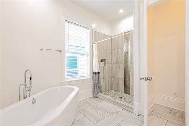 1379 Saint Anthony St, New Orleans, LA 70116 - bathroom featuring a freestanding bath and a tile shower