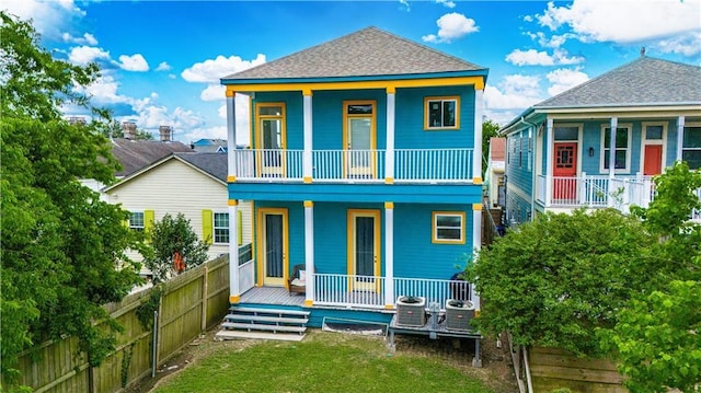 1379 Saint Anthony St, New Orleans, LA 70116 - back of house featuring a porch, fence, a balcony, a yard, and a shingled roof