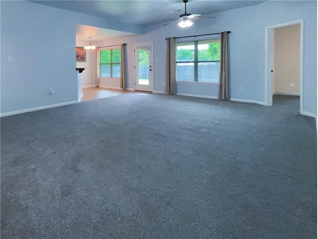 11601 Mary Lee Dr, Denham Springs, LA 70726 - unfurnished living room featuring baseboards, carpet flooring, ceiling fan with notable chandelier, and a wealth of natural light