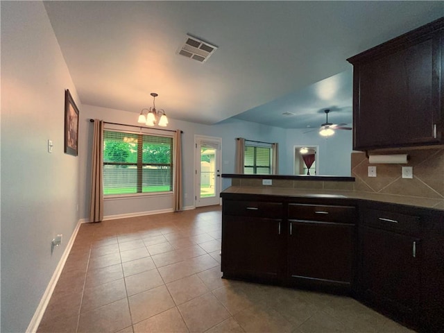 11601 Mary Lee Dr, Denham Springs, LA 70726 - kitchen with baseboards, tasteful backsplash, light tile patterned flooring, and visible vents