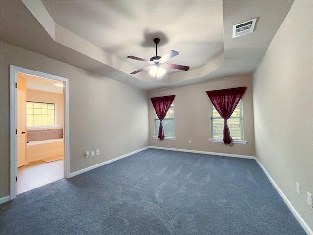 11601 Mary Lee Dr, Denham Springs, LA 70726 - carpeted empty room featuring baseboards, ceiling fan, a tray ceiling, and visible vents