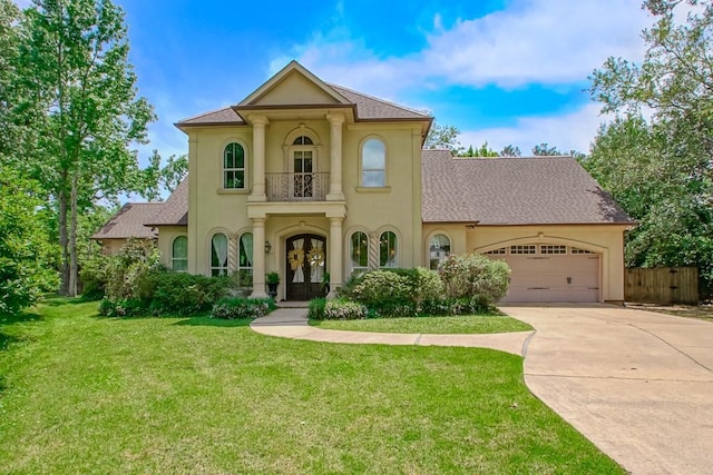 mediterranean / spanish house featuring french doors, an attached garage, driveway, and stucco siding