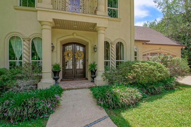 property entrance featuring french doors and stucco siding