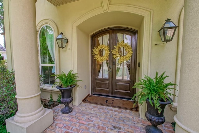 entrance to property with stucco siding and french doors