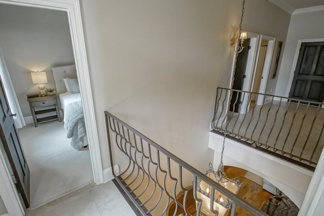 corridor with crown molding and baseboards