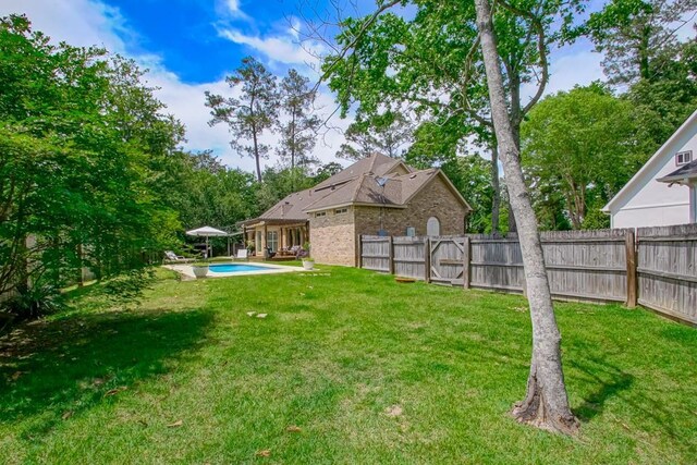 view of yard with a fenced backyard, a fenced in pool, and a patio area