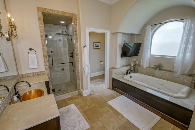 bathroom with stone tile floors, a shower stall, a bath, and vanity
