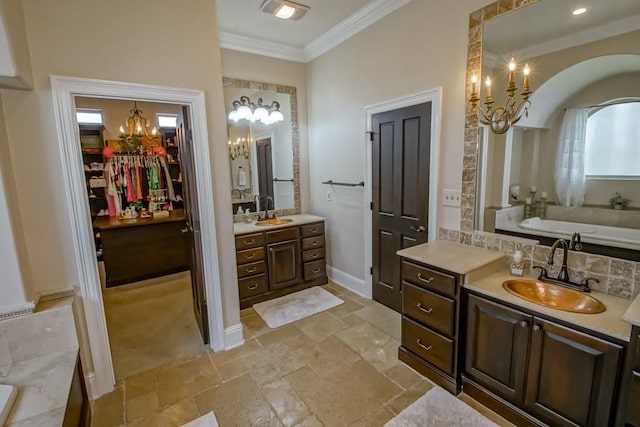 full bath with a sink, stone tile floors, two vanities, and a notable chandelier