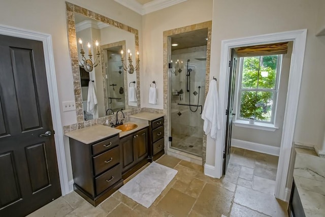 full bath featuring crown molding, stone tile floors, vanity, baseboards, and a stall shower