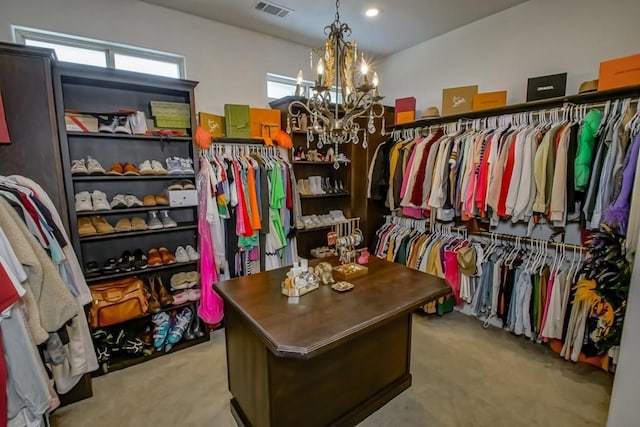 walk in closet with carpet, a chandelier, and visible vents