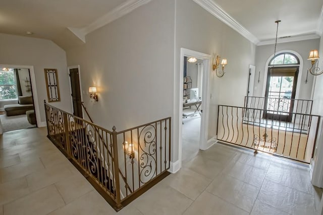 hall featuring baseboards, an upstairs landing, and ornamental molding