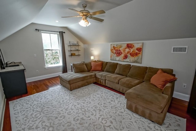 living area with visible vents, wood finished floors, lofted ceiling, baseboards, and ceiling fan