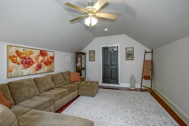 living room with baseboards, a ceiling fan, lofted ceiling, and wood finished floors