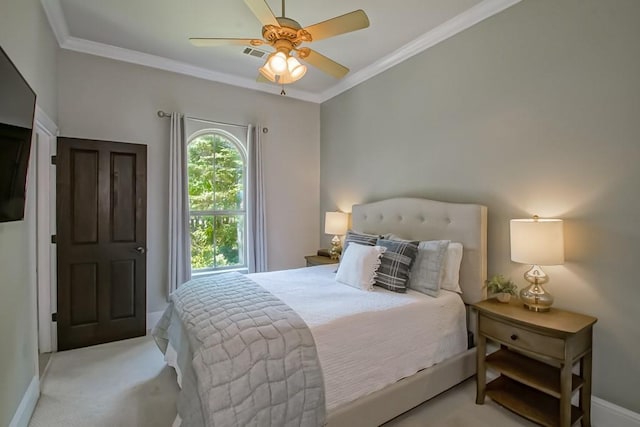 carpeted bedroom featuring baseboards, ornamental molding, a ceiling fan, and visible vents