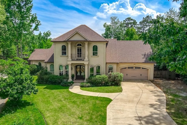 mediterranean / spanish home with french doors, a garage, a balcony, a front lawn, and stucco siding
