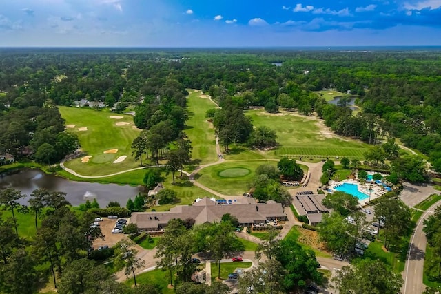 aerial view featuring a water view, a view of trees, and view of golf course