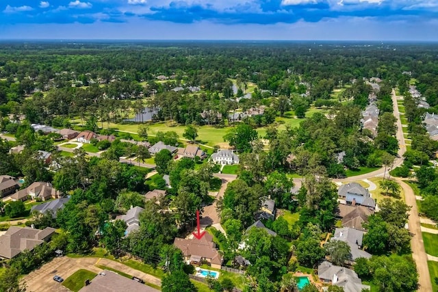 birds eye view of property with a water view, a view of trees, and a residential view