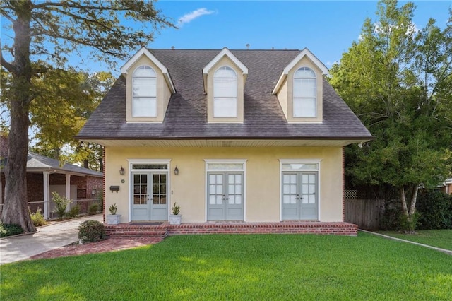 310 Orpheum Ave, Metairie, LA 70005 - view of front facade with fence, french doors, a front lawn, and stucco siding