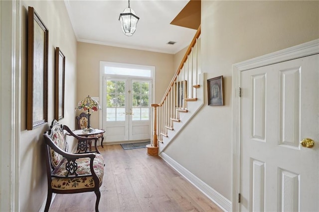 310 Orpheum Ave, Metairie, LA 70005 - foyer entrance with french doors, light wood-style flooring, stairs, visible vents, and ornamental molding