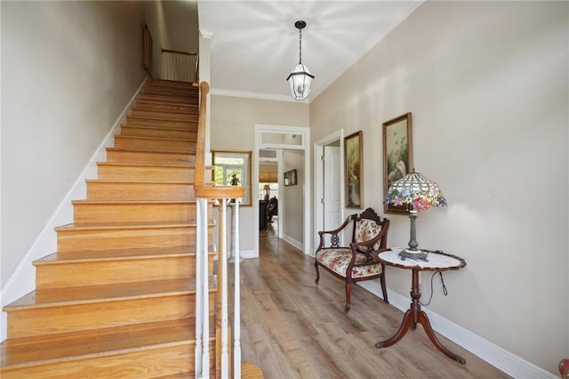 310 Orpheum Ave, Metairie, LA 70005 - stairway with crown molding, baseboards, and wood finished floors