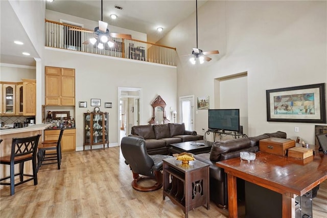 310 Orpheum Ave, Metairie, LA 70005 - living room with light wood-type flooring, ceiling fan, and a high ceiling