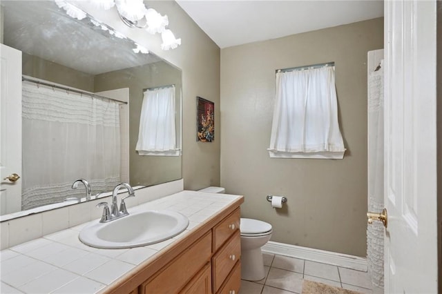 310 Orpheum Ave, Metairie, LA 70005 - full bathroom featuring vanity, toilet, tile patterned floors, plenty of natural light, and baseboards