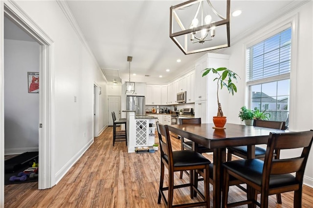 3301 Loyola Ave, New Orleans, LA 70115 - dining space with baseboards, ornamental molding, and light wood-type flooring