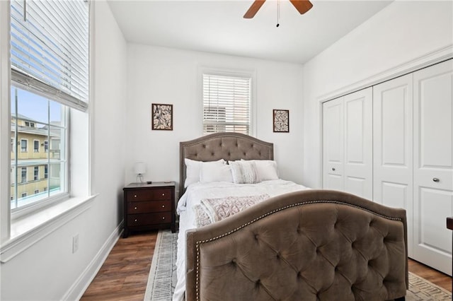 3301 Loyola Ave, New Orleans, LA 70115 - bedroom featuring multiple windows, a ceiling fan, a closet, and wood finished floors
