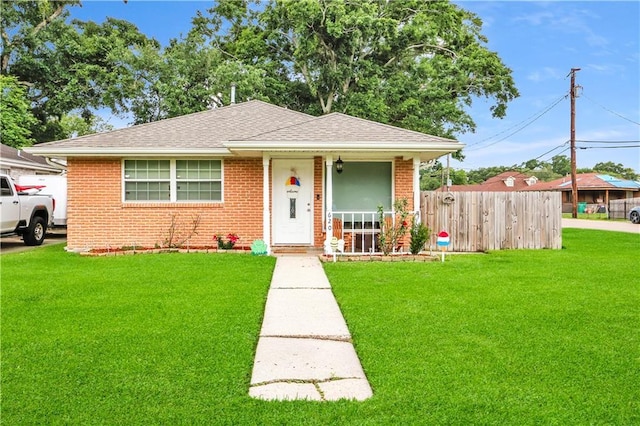 620 Maryland Ave, Metairie, LA 70003 - view of front of house featuring a porch, fence, a front lawn, and brick siding